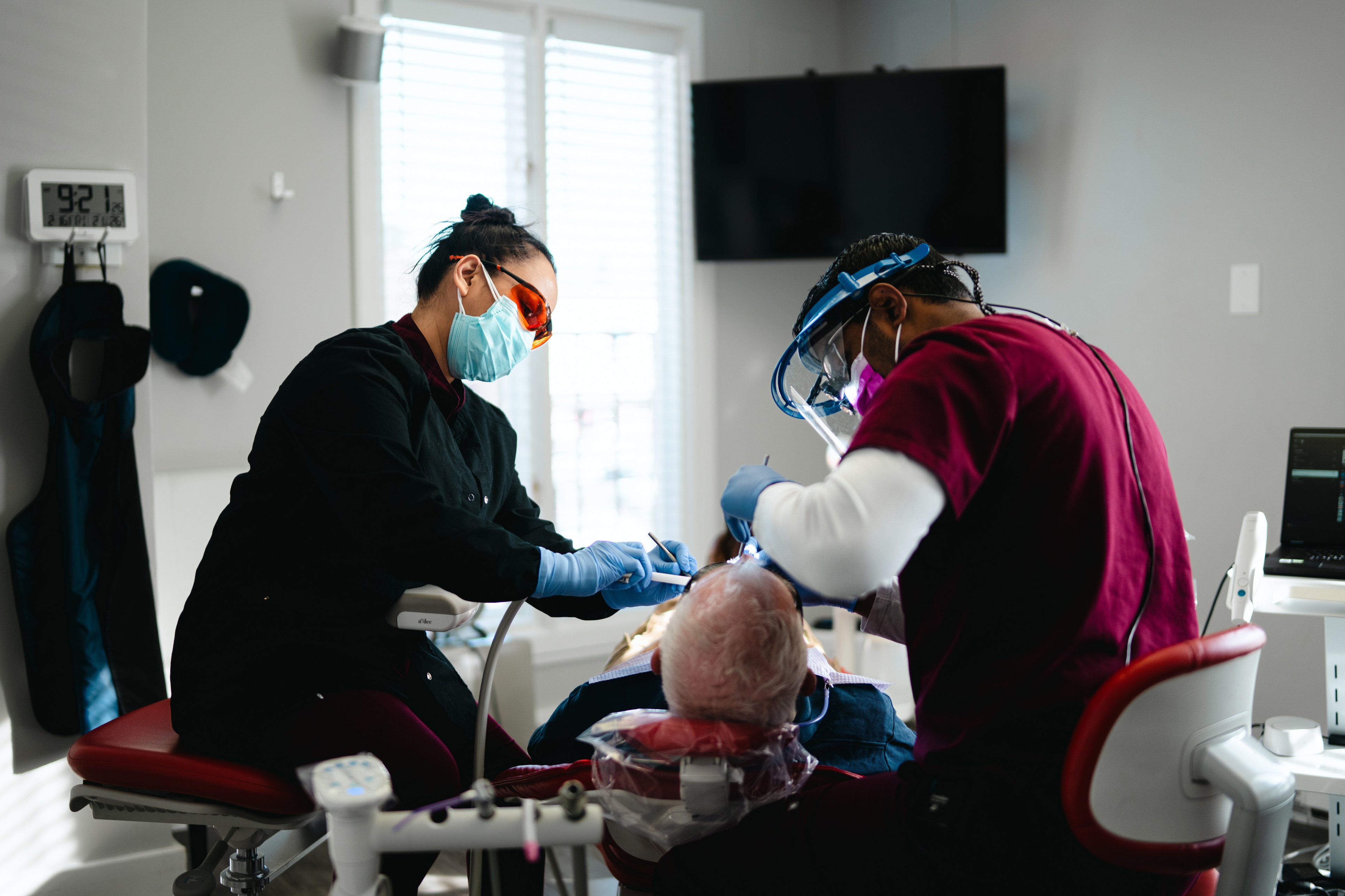 Dentist and assistant working with patient