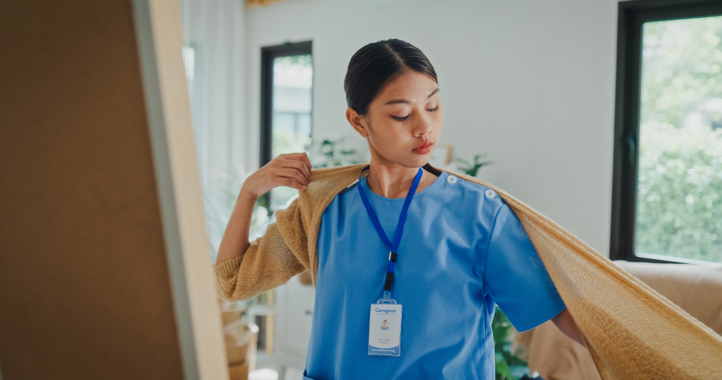 Nurse putting on sweater